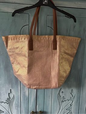 Metallic Rose Gold Tote Bag with Brown Handles/zippered pocket magnet close. $25